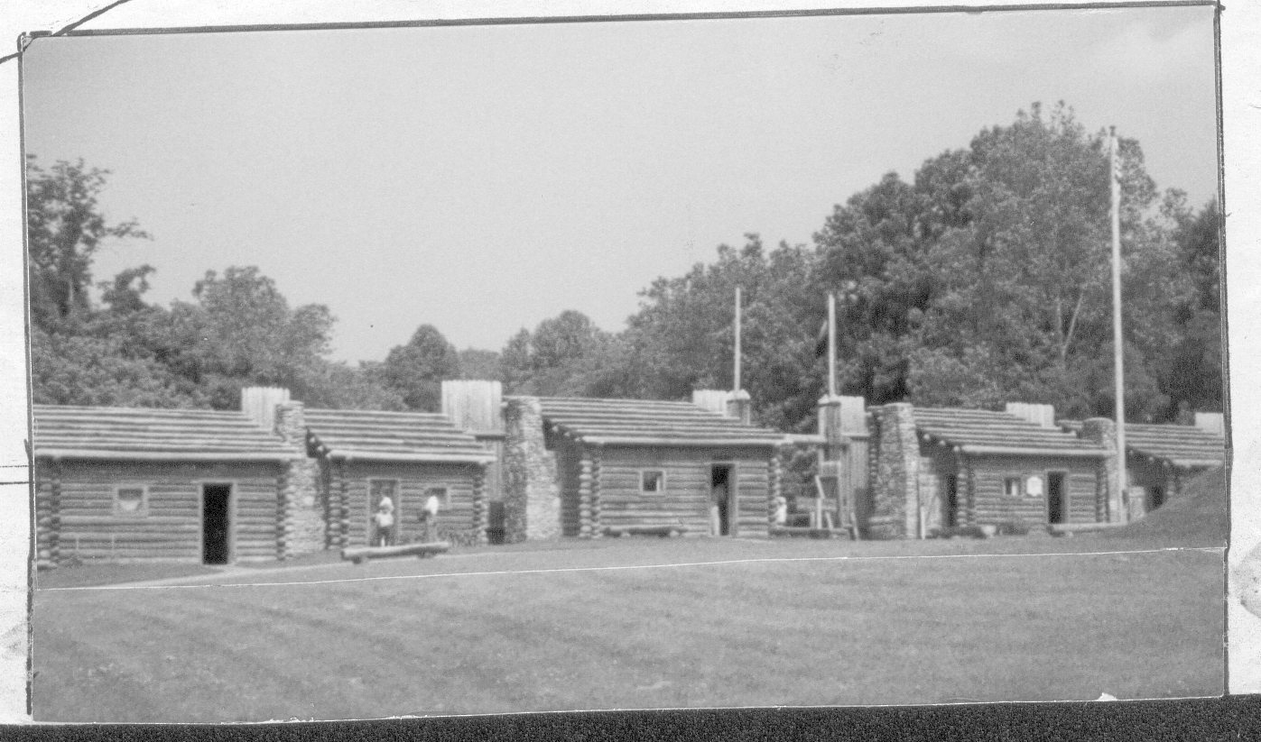 black and white photo of log cabins